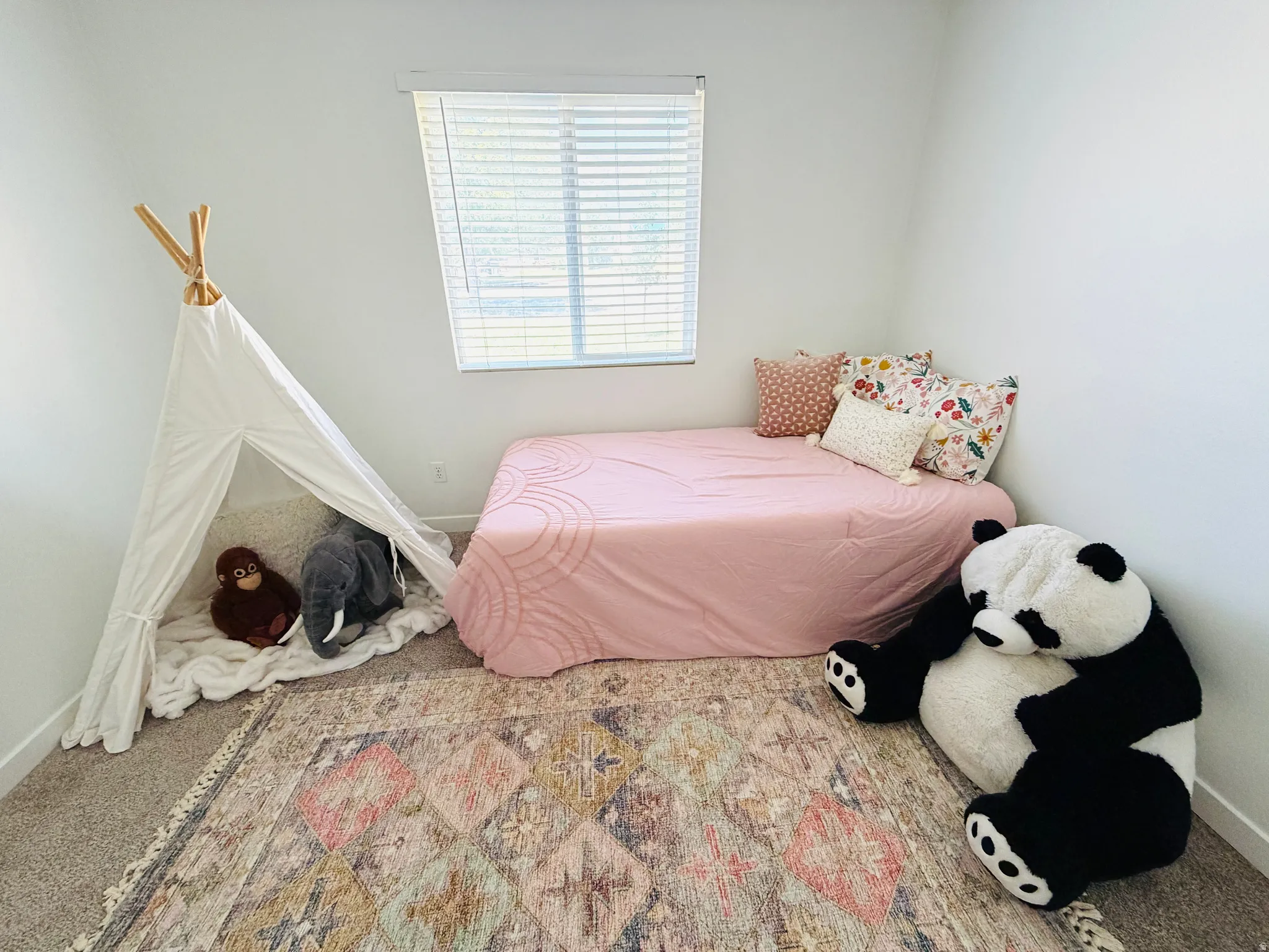 Bedroom featuring neutral wall paint, carpet flooring, and a window with horizontal blinds
