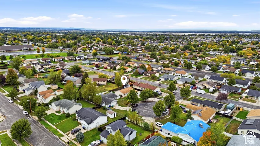 Aerial perspective of a suburban neighborhood featuring tree-lined streets, a cul-de-sac, and established residential lots