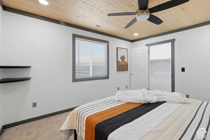 Tongue-and-groove wood-paneled ceiling, dark-trim window and door casings, recessed lighting, ceiling fan with integrated light fixture, and floating corner shelving