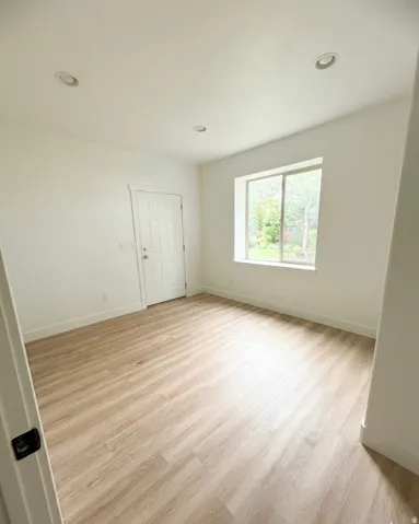 Light wood-finish flooring complements the neutral wall tones of this room