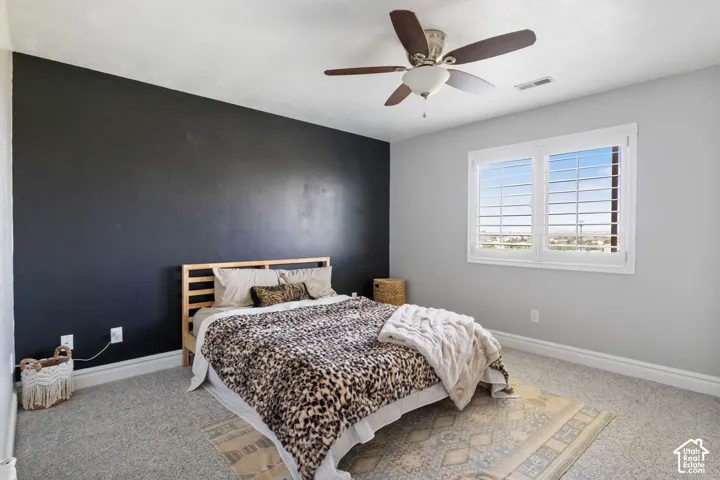 Room featuring a statement black accent wall, light gray painted walls, and gray carpeting