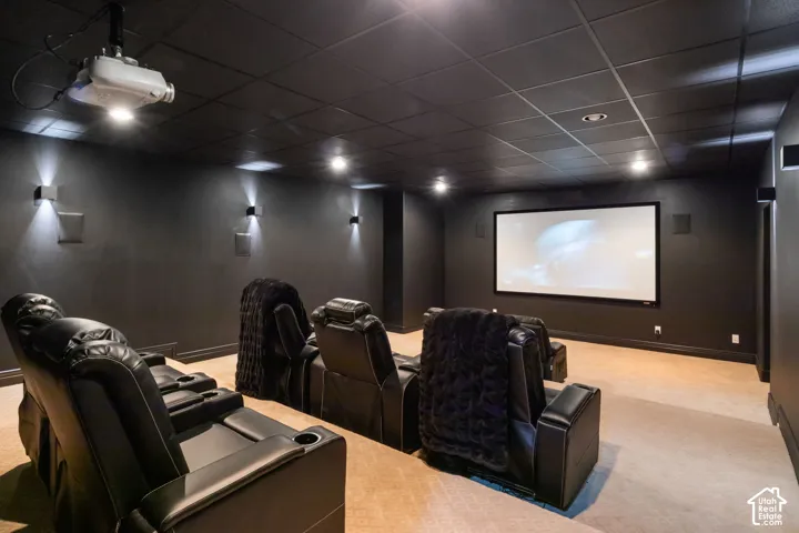 Dedicated home theater with a large projection screen and ceiling-mounted projector