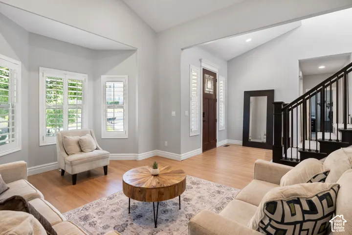 Vaulted ceilings complement the wood-finish flooring in this entry and living area