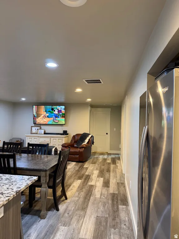 Open-concept living area with LVP flooring. Dining room table and chairs included.