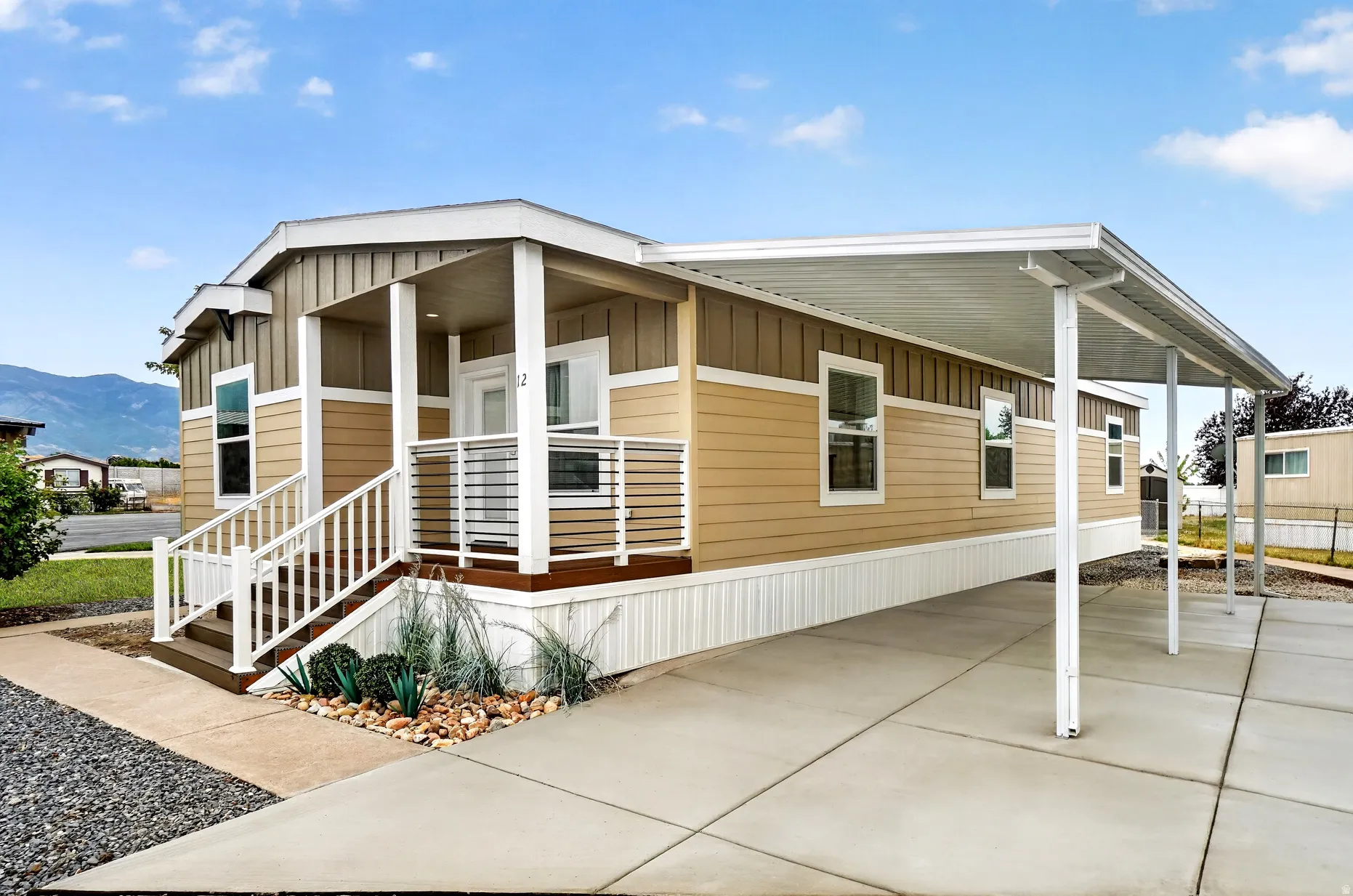 Two-tone exterior with covered front entry and white railing