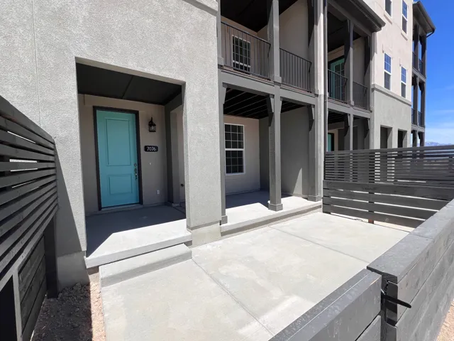 Private concrete patio with dark wood-finish fencing