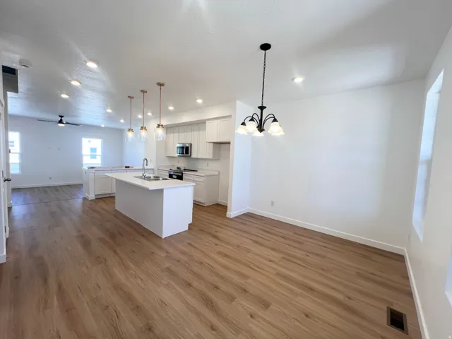 Open-concept living area featuring wood-finish flooring