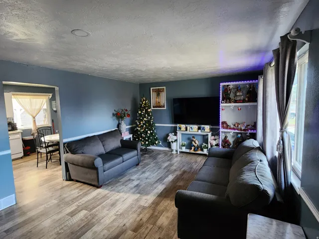 Living area featuring wood-finish flooring and recessed ceiling lighting