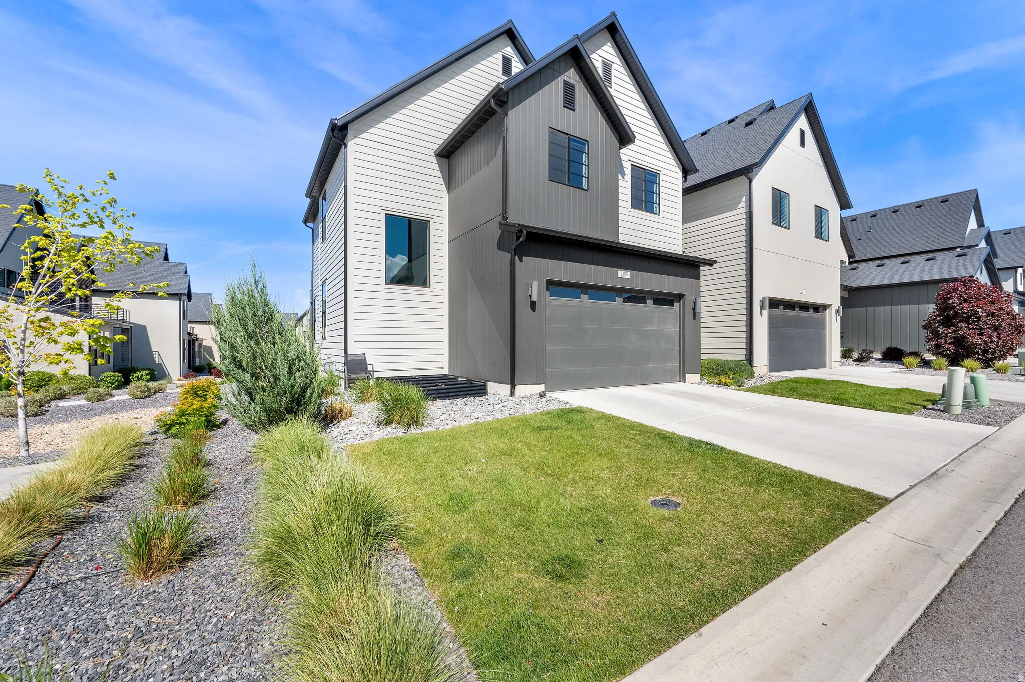 Contemporary exterior with a dark gray and light-toned siding combination