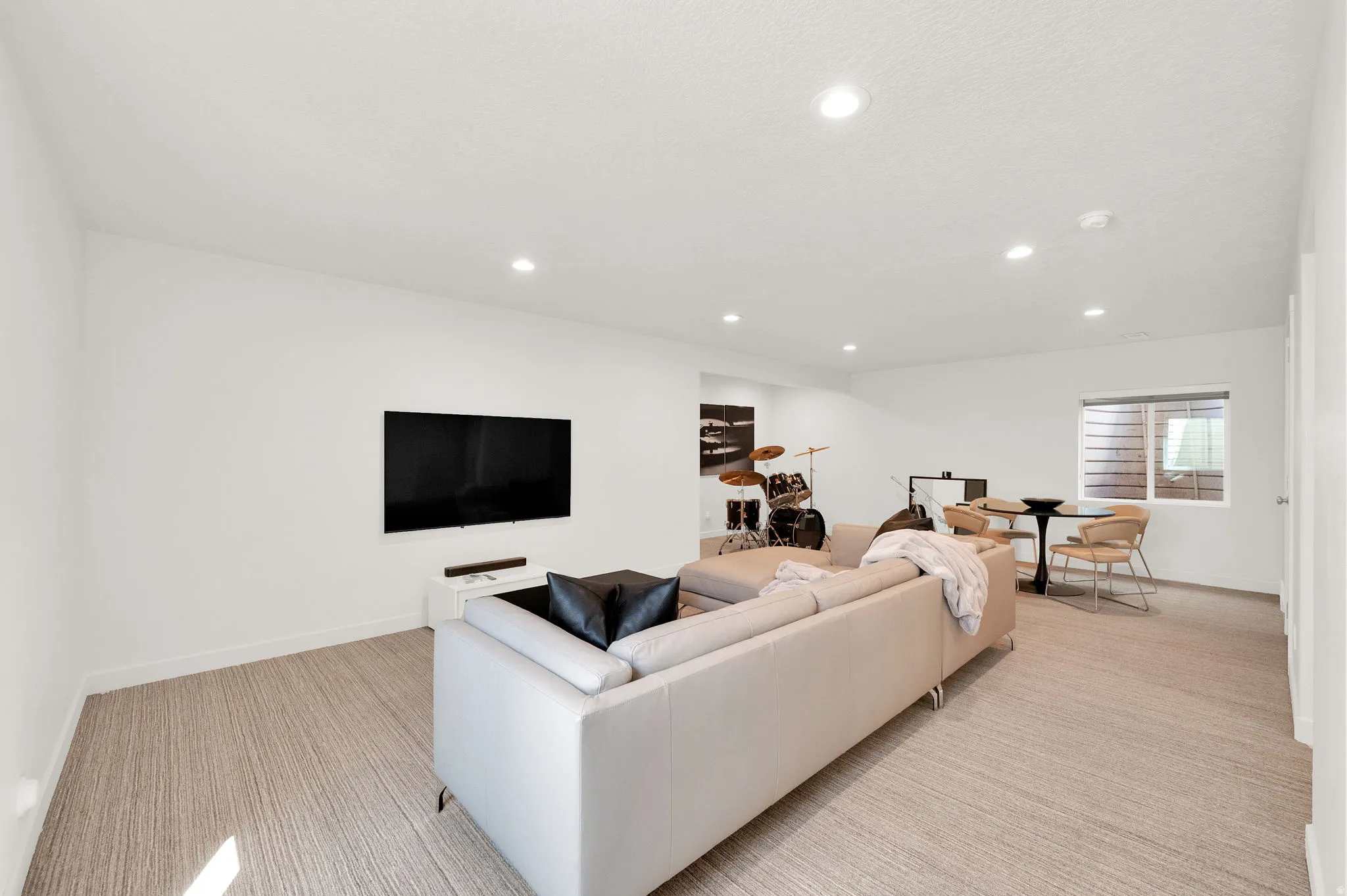 Spacious recreation area featuring carpet flooring and recessed lighting