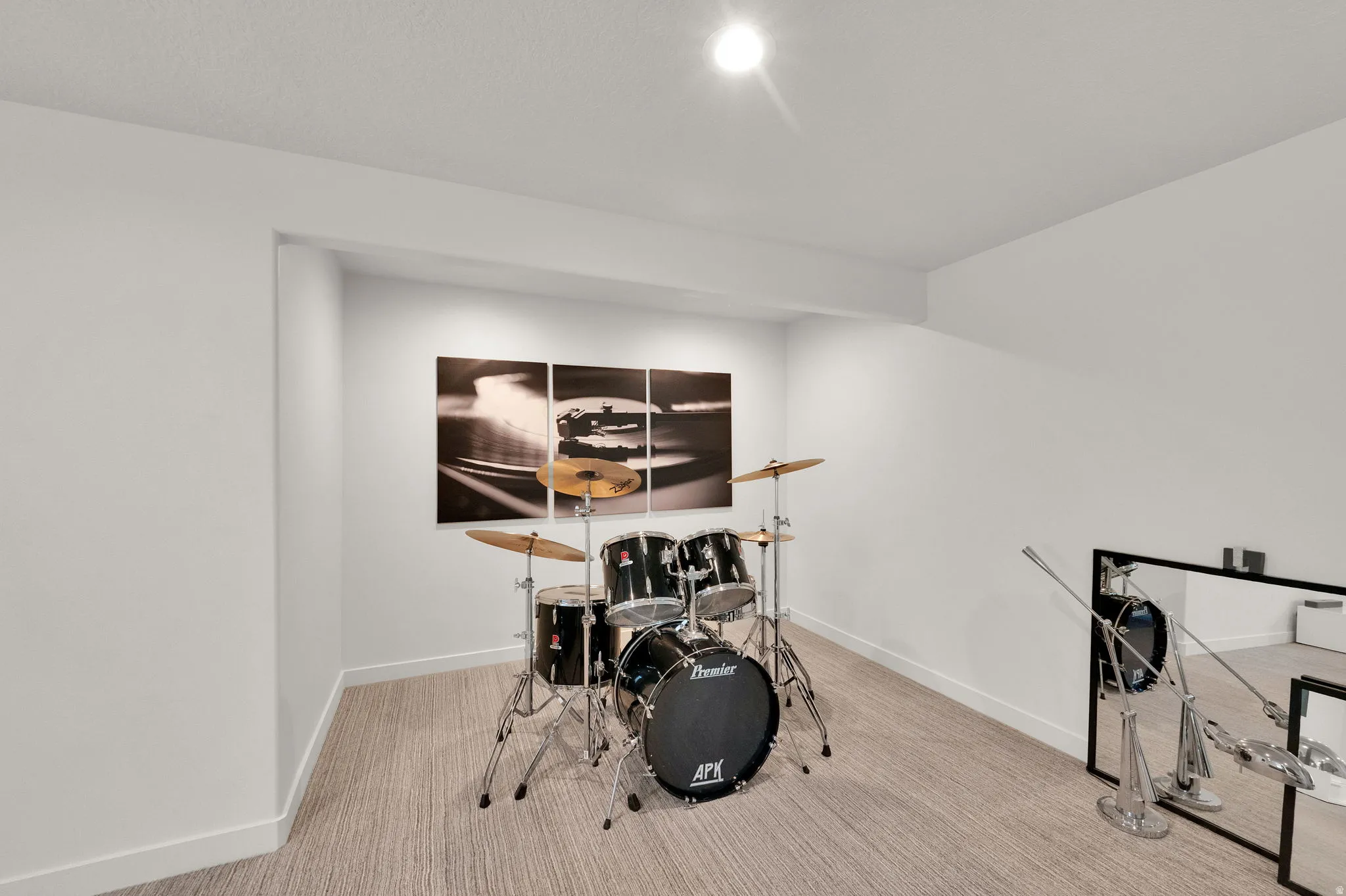 Recessed alcove with integrated ceiling lighting, light-toned carpet flooring, and crisp white baseboards