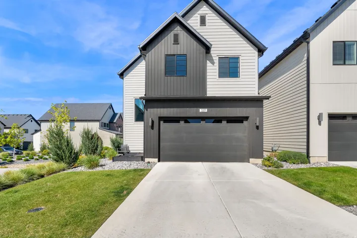 Modern exterior featuring white siding and dark board and batten accents
