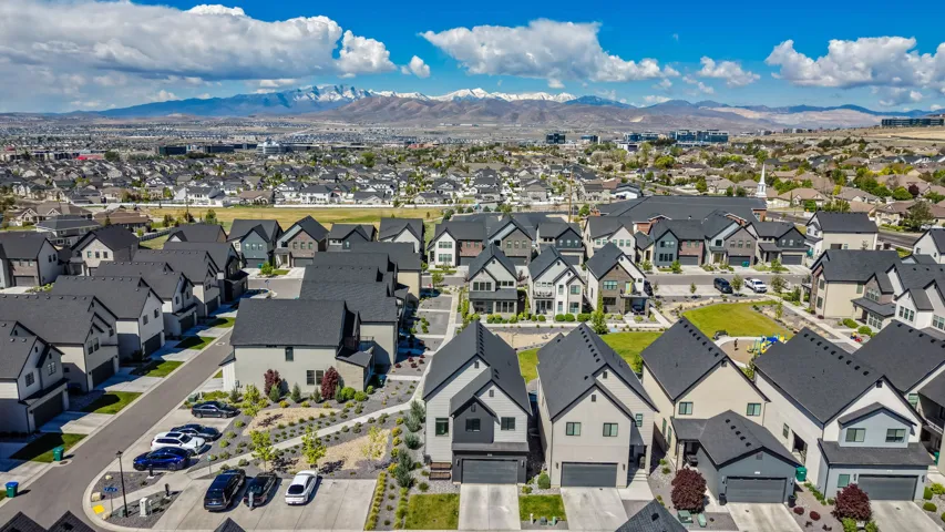 Modern residential community featuring varied architectural styles and dark asphalt shingle roofs