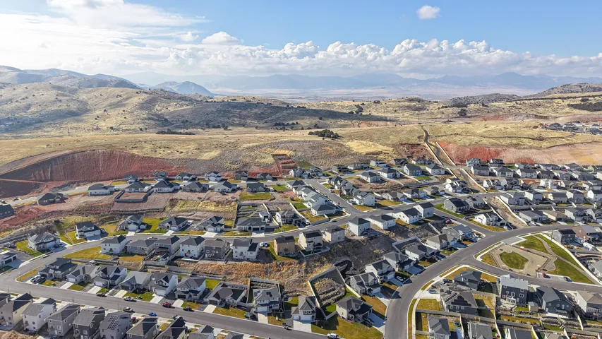 Expansive aerial panorama showcasing a residential development with numerous single-family homes