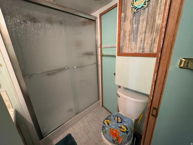 Shower enclosure featuring frosted glass sliding doors and a metal frame