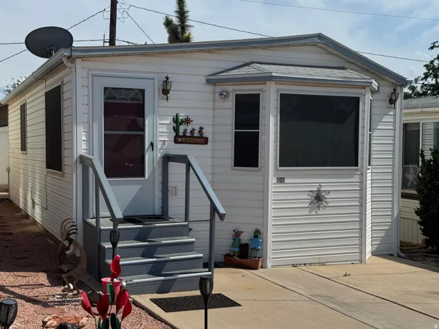 White siding exterior with a pitched roof and a bay window