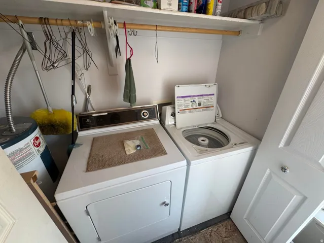 Dedicated utility area featuring a white top-load washing machine and front-load dryer