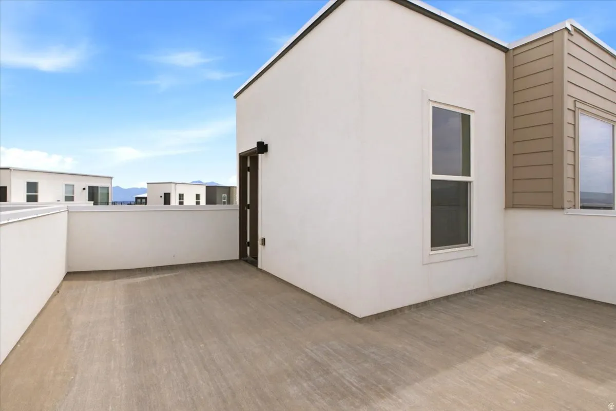 Expansive rooftop patio with concrete flooring