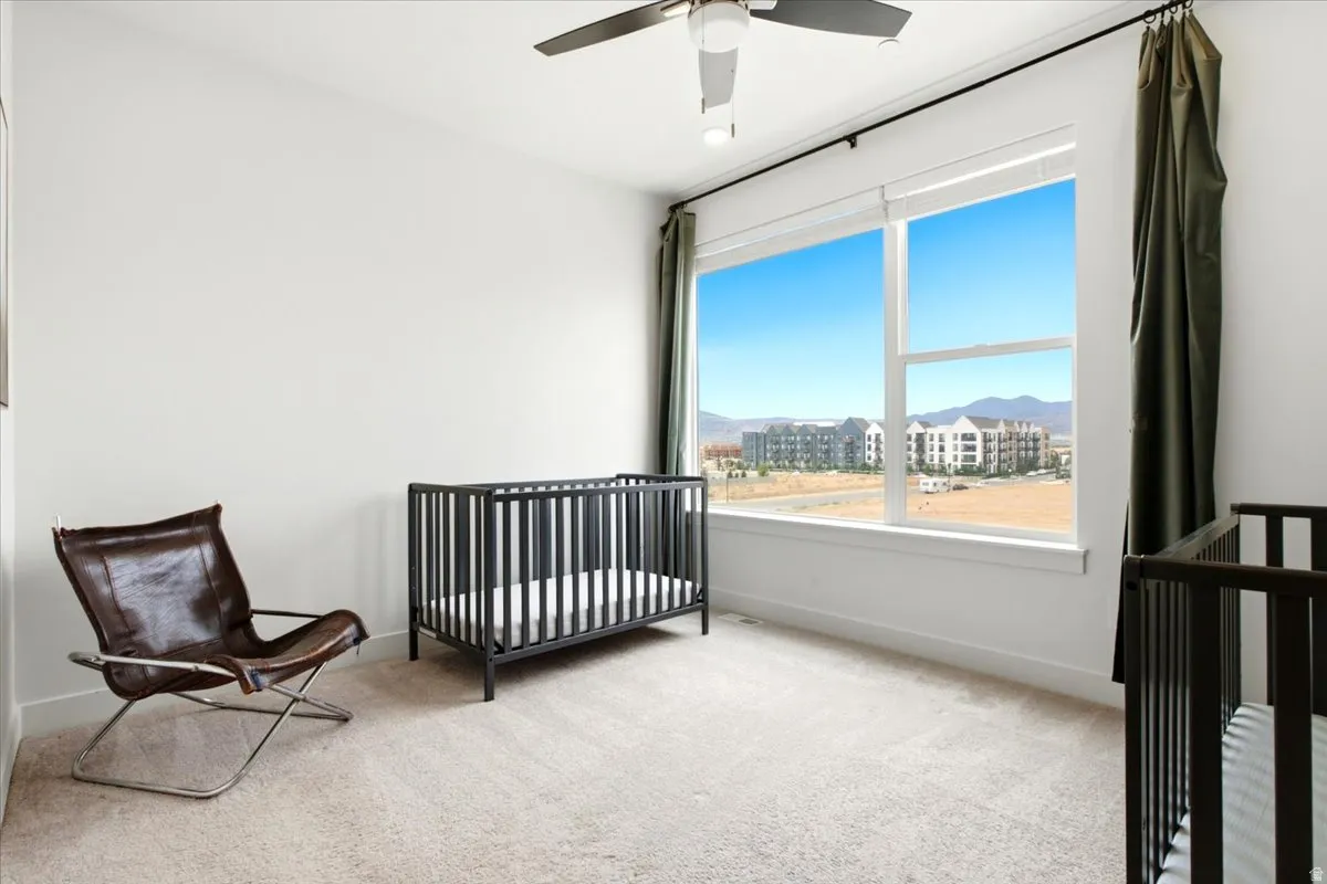 Bright room with expansive window providing distant mountain and urban scenery
