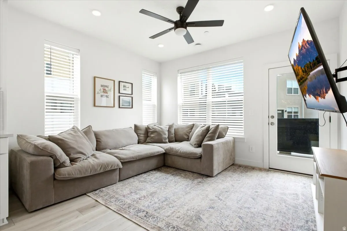 Bright living area featuring wood-finish flooring and a glass-paneled exterior door