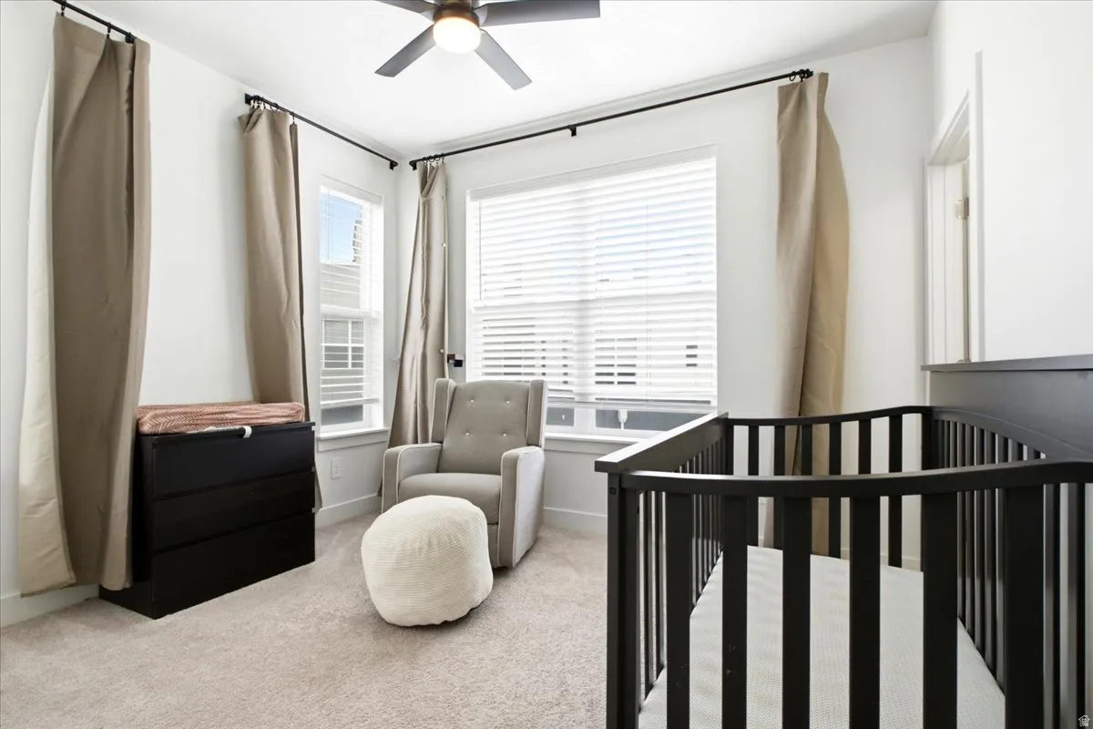 Light-filled room featuring neutral carpeting and white wall finishes