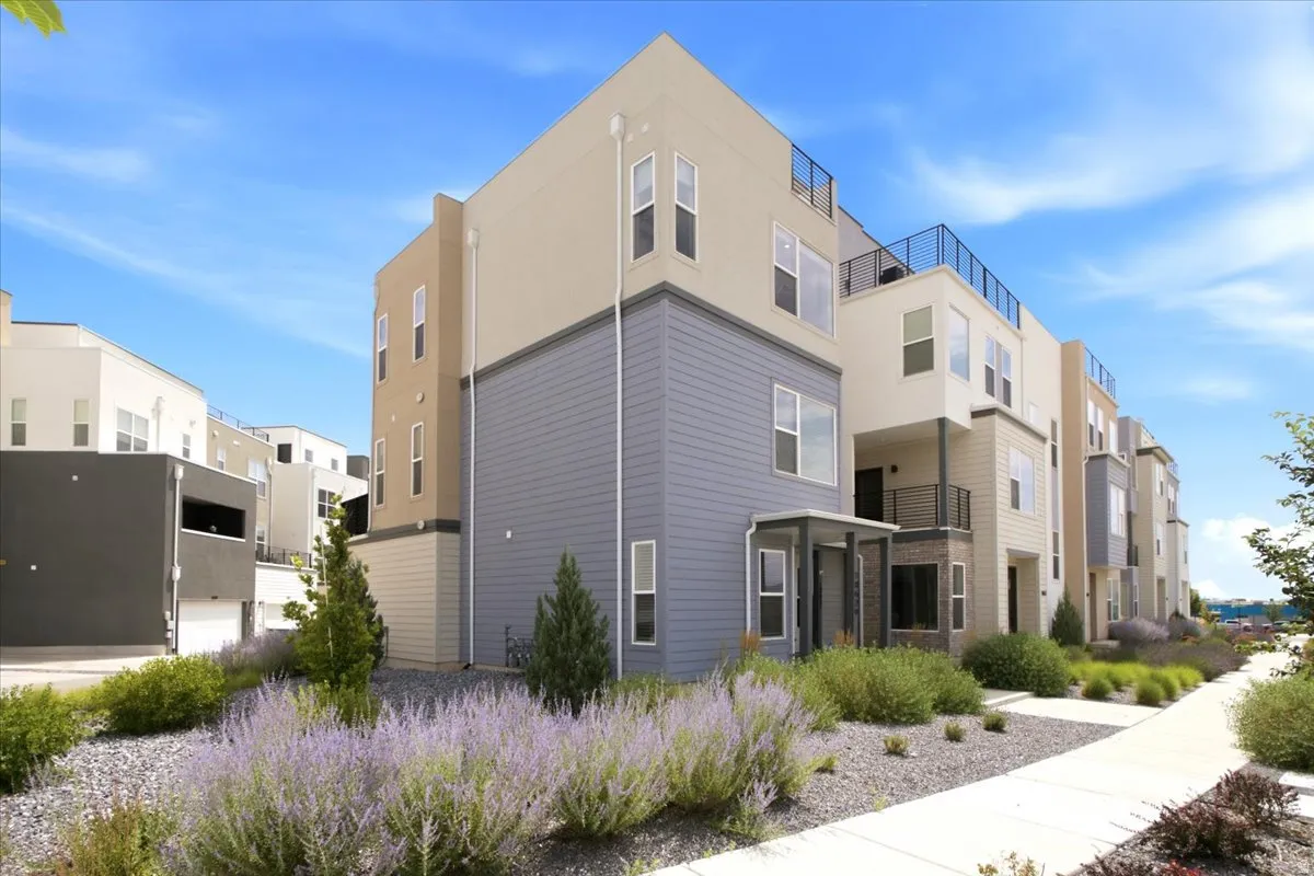 Contemporary multi-level exterior featuring varied siding materials and a flat roofline