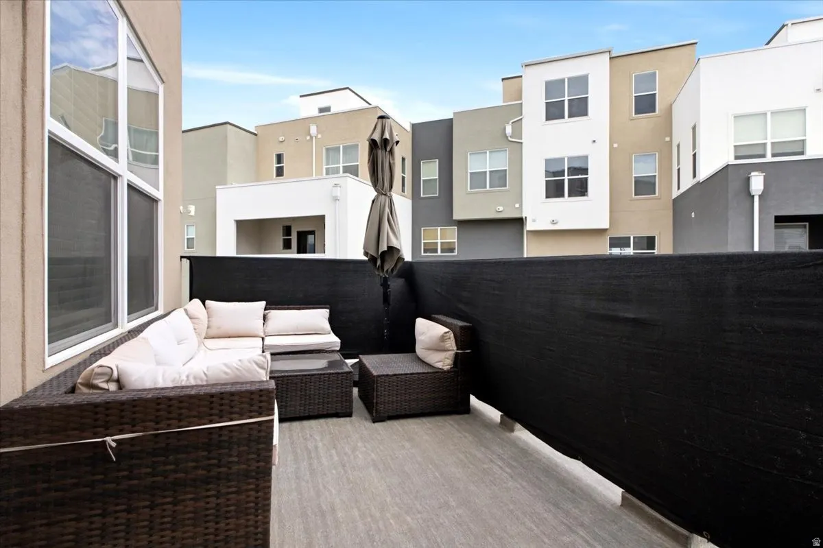 Outdoor patio space featuring wood-finish flooring and a privacy screen