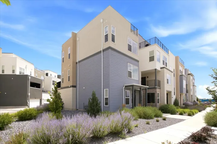 Contemporary multi-level exterior featuring varied siding materials and a flat roofline