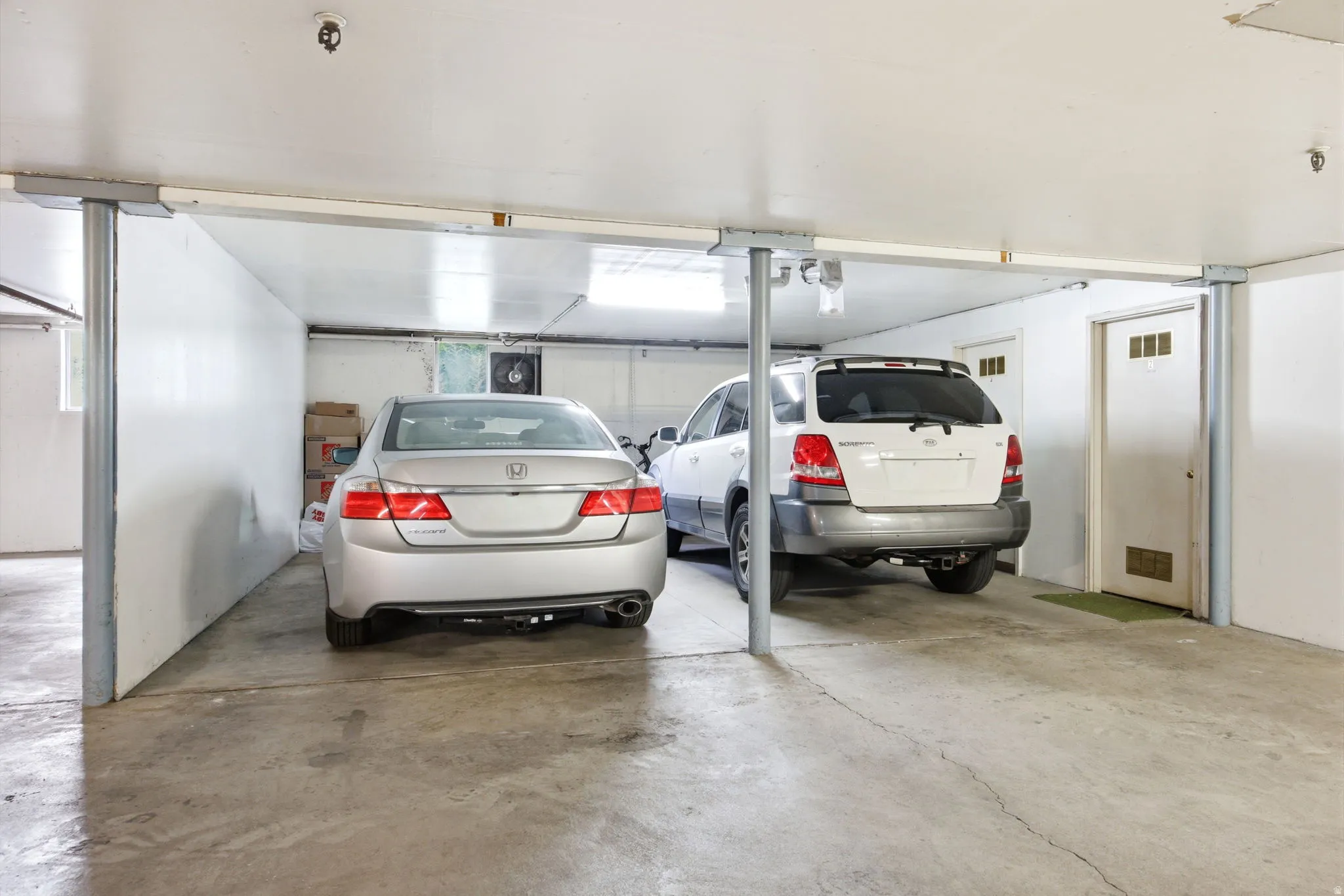 Enclosed garage space featuring a concrete floor and white walls