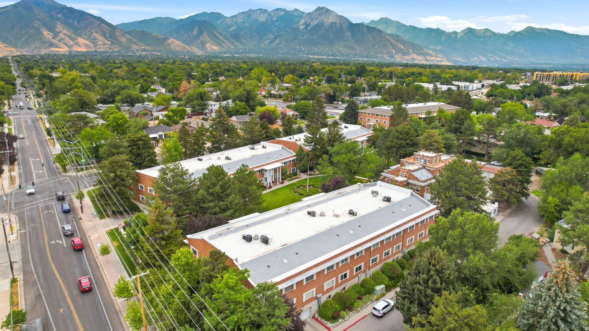 Aerial perspective showcasing multiple buildings with brick exteriors and light-colored roofs
