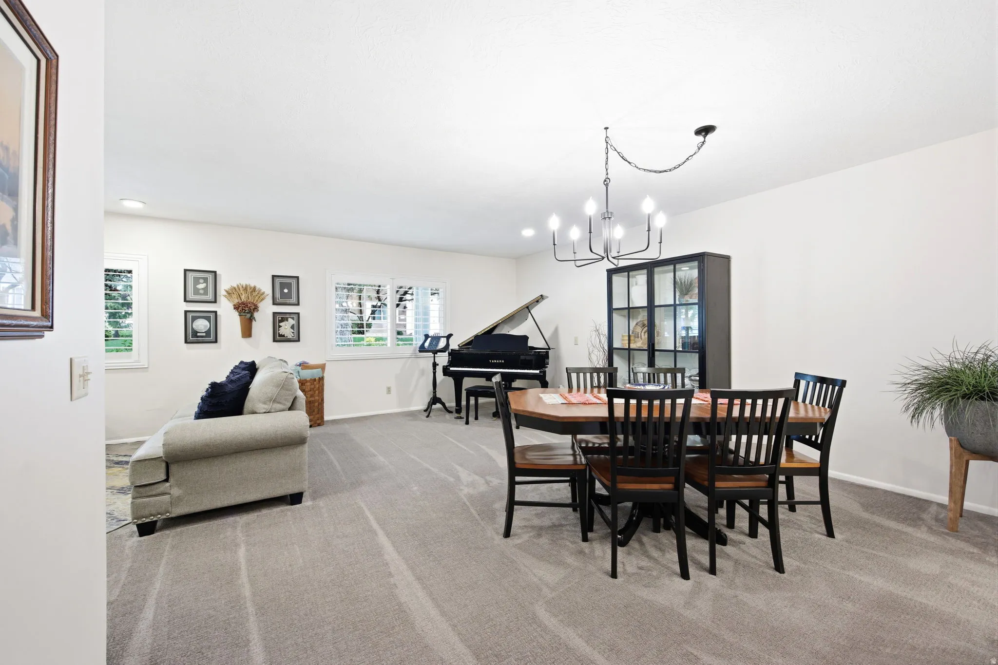 Spacious room featuring light gray carpeting and white walls