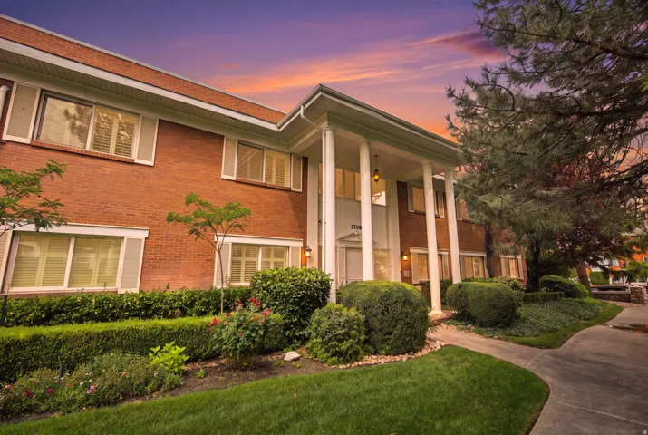 Brick exterior with white shutters and a stately columned entrance