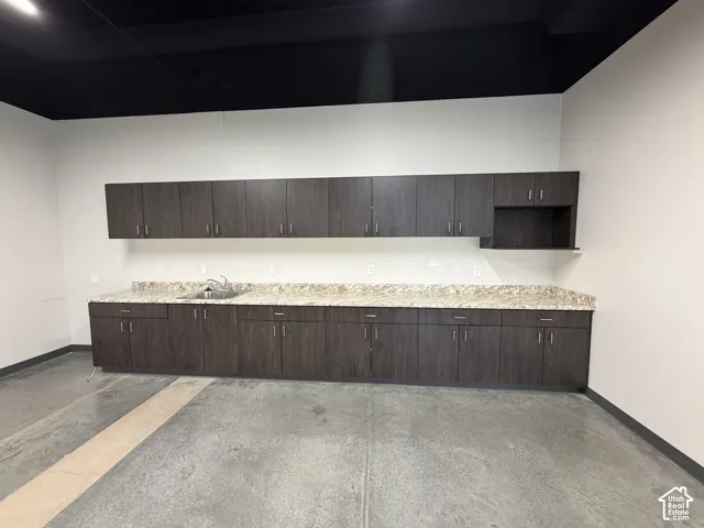 Extensive cabinetry with wood-finish doors, durable countertops, and an integrated sink