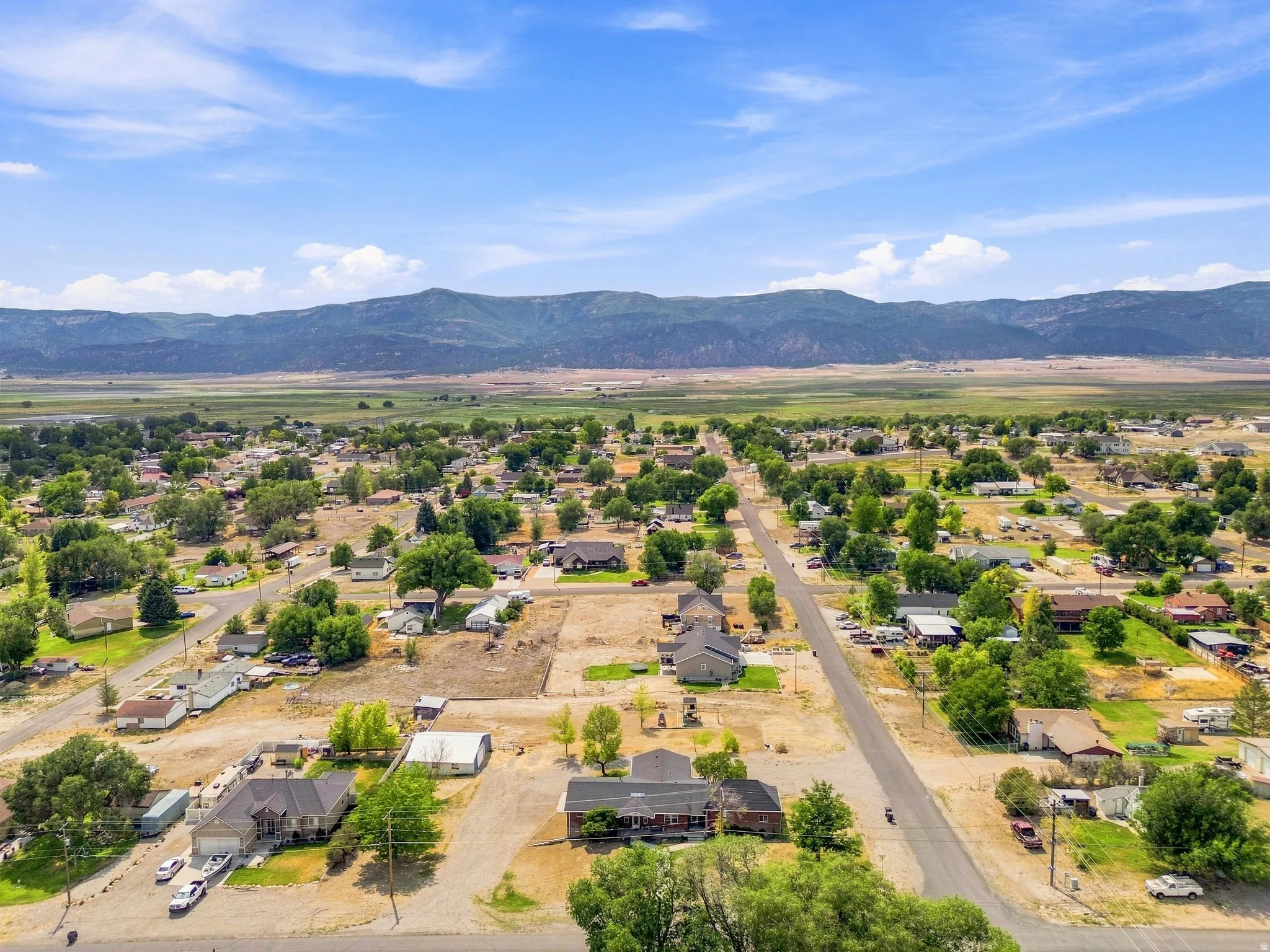 Expansive aerial perspective showcasing a residential community with abundant mature trees and individual properties