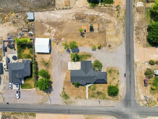 Aerial perspective showcasing a property with extensive land