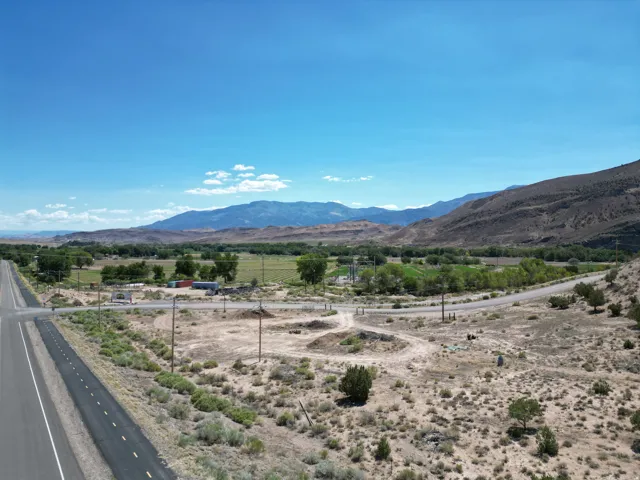 Expansive vacant land offering panoramic mountain vistas and established irrigation infrastructure