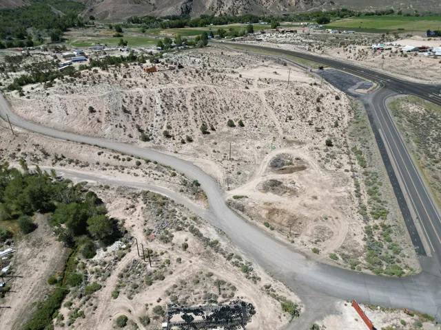 Expansive undeveloped land featuring a network of unpaved roads and a partial paved road frontage