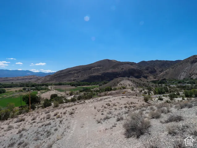 Expansive land parcel featuring desert landscaping and distant mountain ranges