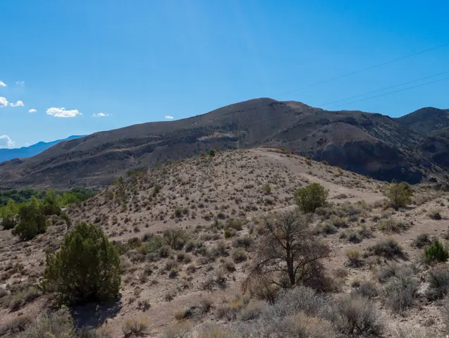 Expansive desert landscape with rolling hills and distant mountains