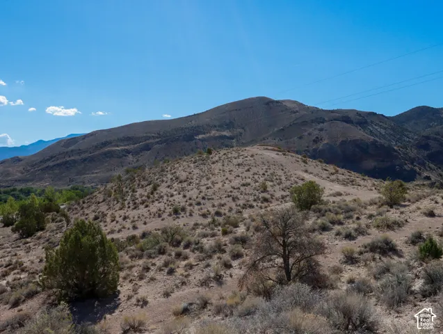 Expansive desert landscape with rolling hills and distant mountains
