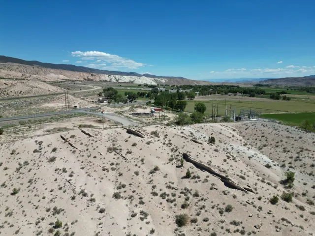 Expansive desert terrain with scattered vegetation and rock formations