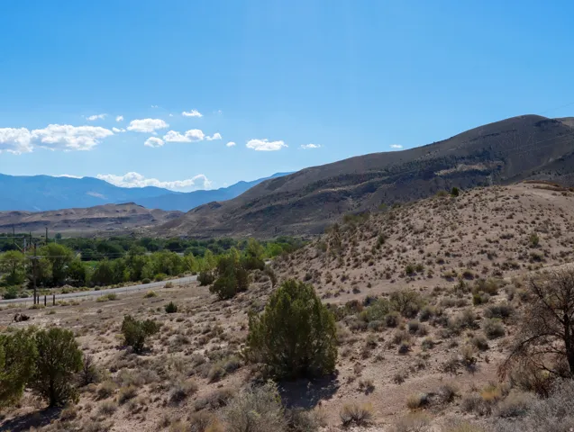 Expansive natural landscape featuring rolling hills and distant mountains