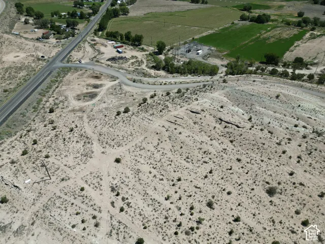 Expansive desert landscape with natural vegetation and visible power lines