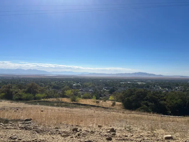 Expansive hilltop parcel with panoramic vistas across the valley and surrounding foliage