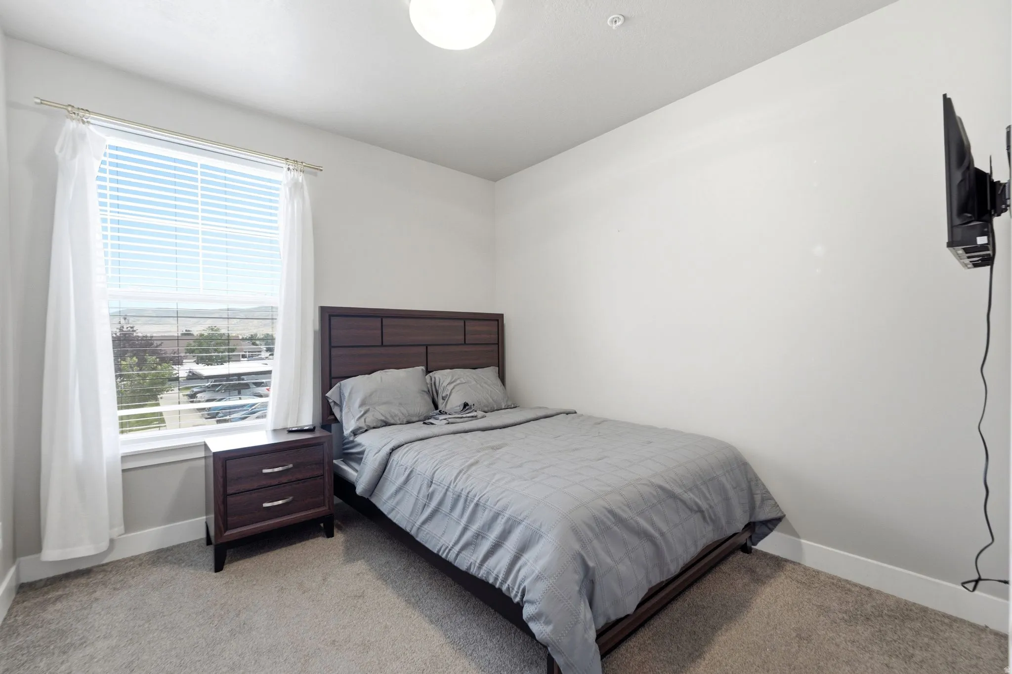 Bright room with an overhead light fixture and a large window