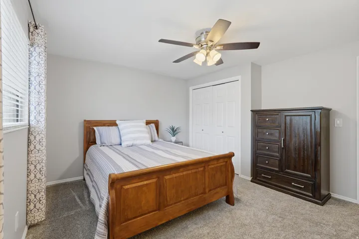 Interior room featuring light gray walls and gray textured carpeting