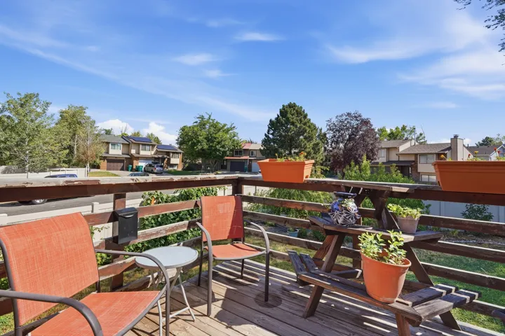 Expansive outdoor deck featuring wood-finish flooring and a wood railing