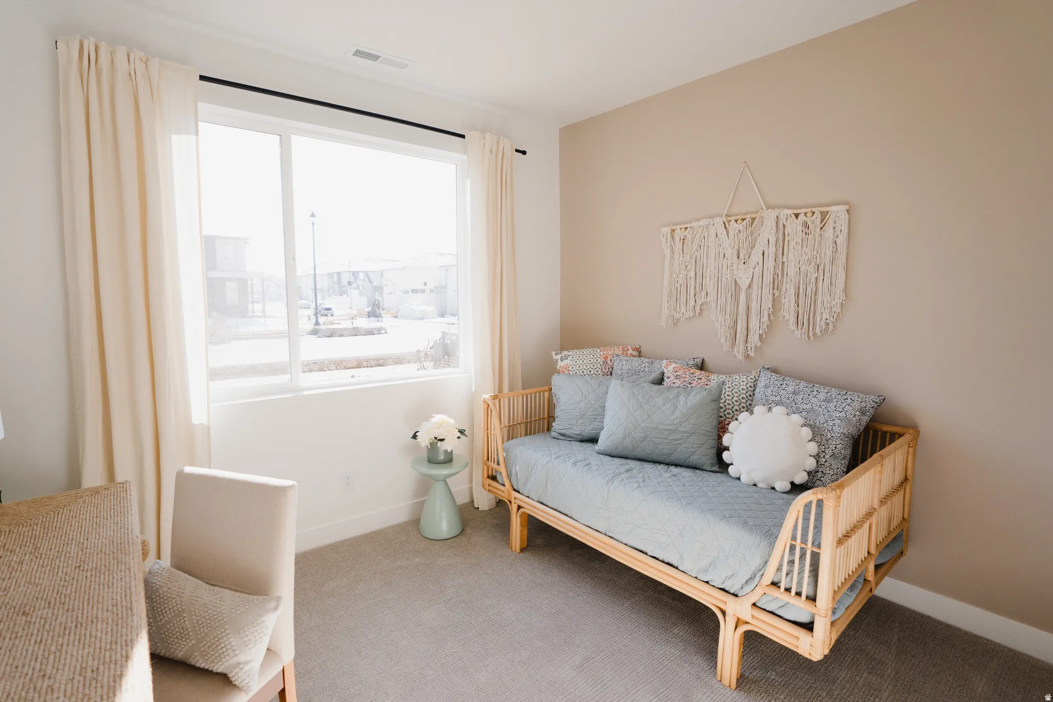 Room featuring a large window with privacy blinds, neutral wall paint, and gray carpet flooring