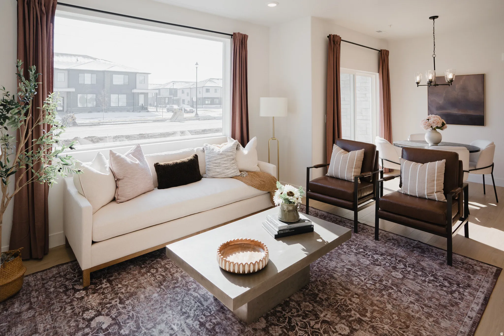 Bright living area featuring a large picture window, recessed lighting, and light wood-finish flooring
