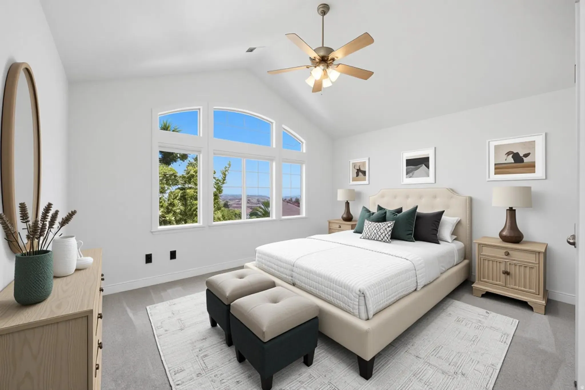 Vaulted ceiling bedroom featuring large arched windows, light gray carpeting, and a ceiling fan with integrated lighting